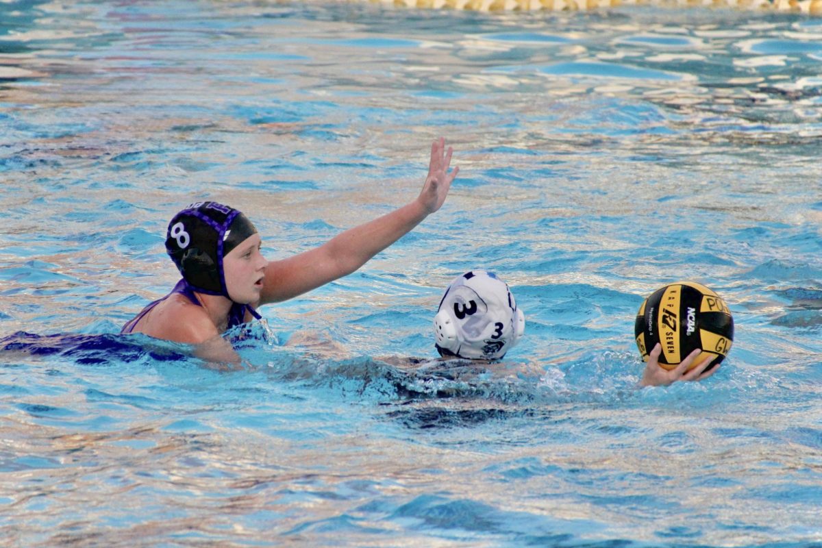 Utility player and sophomore Kennedy Guenard blocks a shot from the Trojans. “We were learning throughout the game,” utility player and senior Emma Saighani-Mirbaz said. “We picked out how they played, and we did really good on focusing on just how to make sure we defend ourselves against them.”