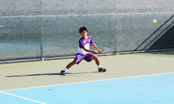 Co-captain and junior Anthony Nguyen prepares for a return during his singles match against Irvine High. “The team played really good,” Nguyen said. “We held our ground. [Even] though the conditions are a little rough, we all played pretty well and we pushed through.”