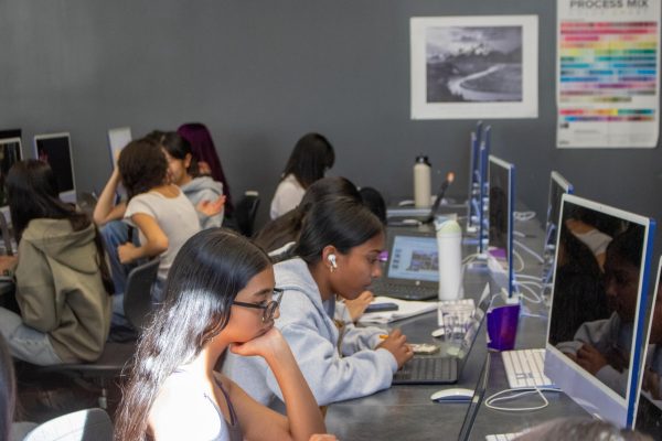 Freshman Zara Saleem and sports editor and sophomore Nikita Thota work on their pages for the 2025-2026 yearbook. “The yearbook documents the school's history, and we try to include all parts of what makes Portola beautiful,” Yearbook adviser Crystal Le said.