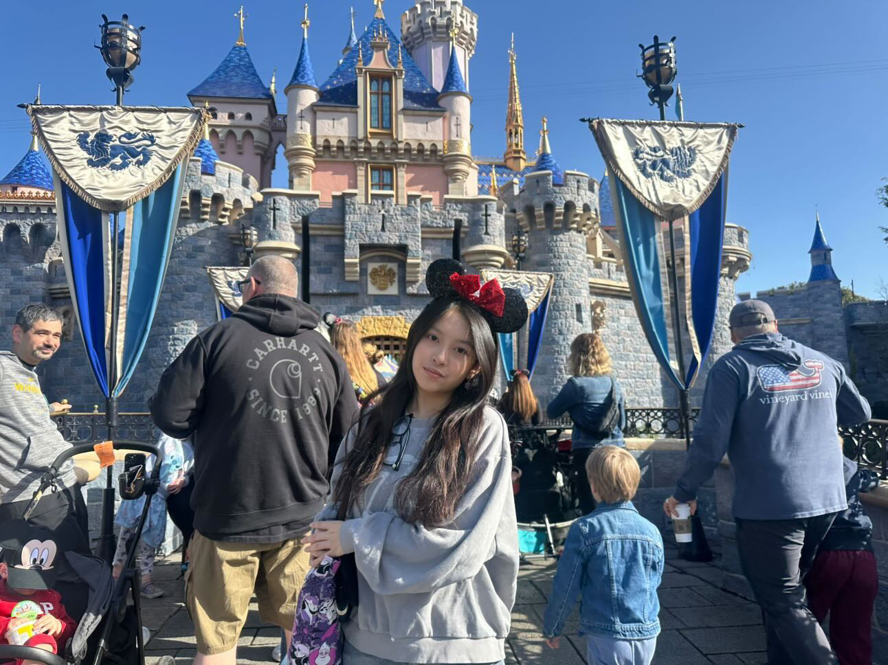Junior Genevie Nguyen poses in front of Disneyland castles. “If I could change one thing about Disney, I think I will add more scary attractions in Adventure Park,” Kim said

