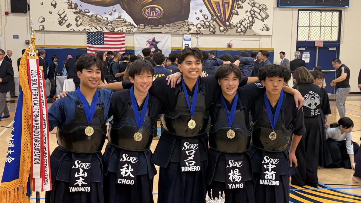 Sophomore Ethan Choo and his teammates celebrate their win at the All United States Kendo Federation Junior Nationals. 