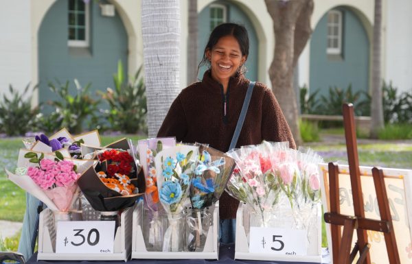 Laughing behind rows of handmade pipe cleaner flower bouquets, sophomore Nikita Kulkarni sells her creations at an Orange County South Asian Student Association event. “I love being creative,” Kulkarni said. “It just takes me away from all the pressure that school causes me, and it’s an outlet for me during my free time.”

