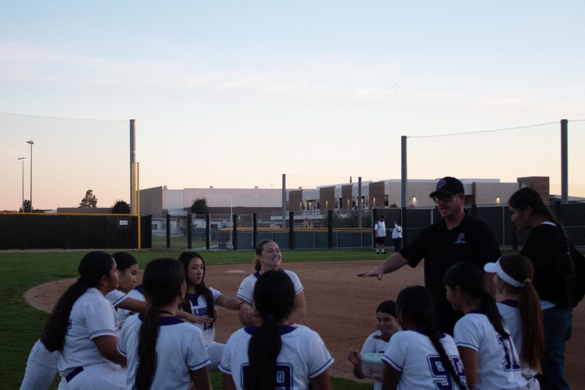 Following their game against La Quinta High on Feb. 25, the softball team debriefs with head softball coach Kevin and prepares for a chant.  “I feel like Coach Kevin instilled a very positive environment,” co-captain and junior Irene Kim said. “Seeing the passion that the girls who have never played the sport [have] and seeing their progress throughout the season makes me feel so proud. Seeing that kind of passion and hope gives me hope for the future of this program.”
