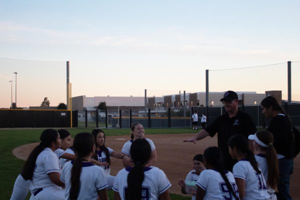 Following their game against La Quinta High on Feb. 25, the softball team debriefs with head softball coach Kevin and prepares for a chant.  “I feel like Coach Kevin instilled a very positive environment,” co-captain and junior Irene Kim said. “Seeing the passion that the girls who have never played the sport [have] and seeing their progress throughout the season makes me feel so proud. Seeing that kind of passion and hope gives me hope for the future of this program.”